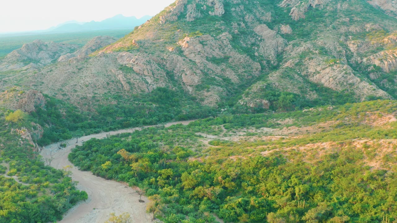 River bend and green valley beneath mountains