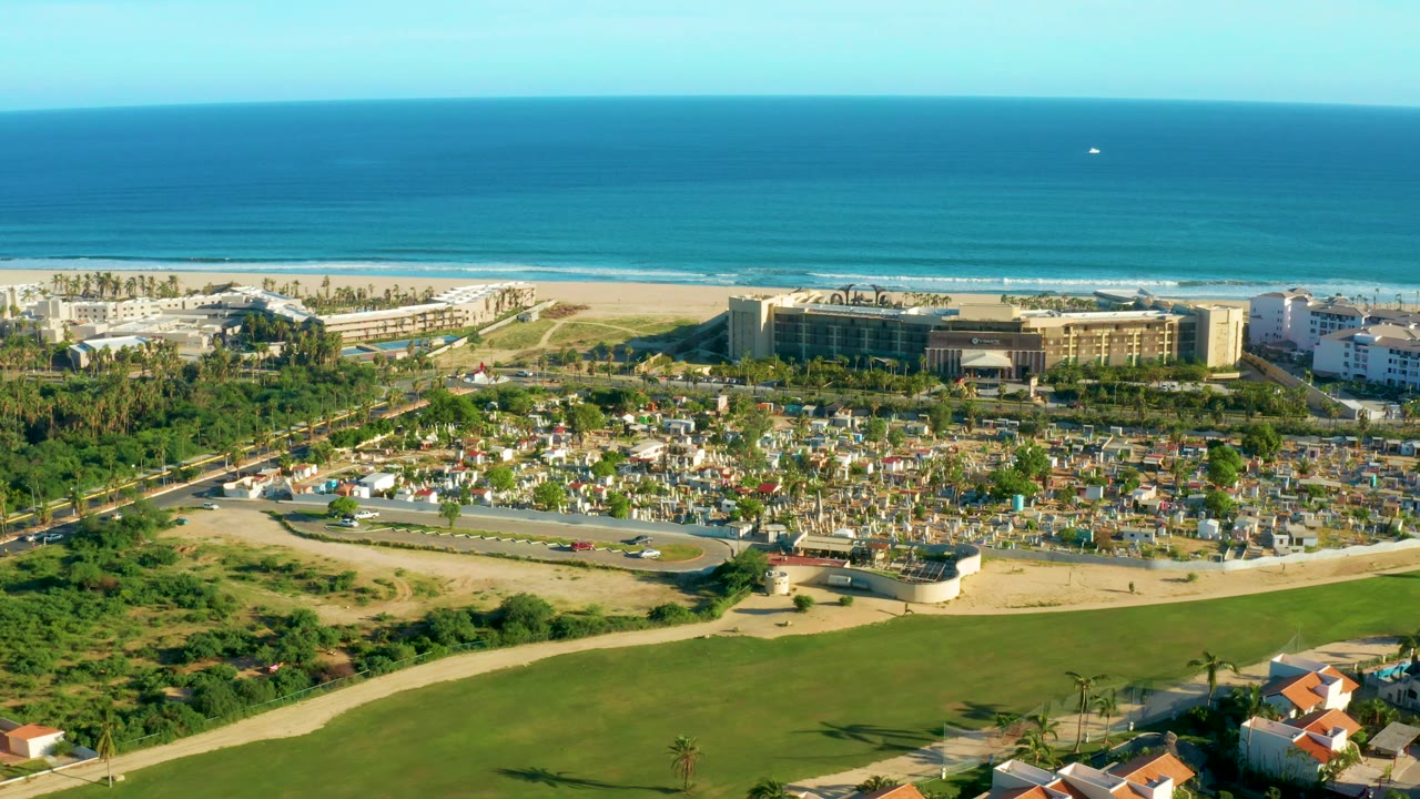 Coastal road and beach buildings under clear blue ocean horizon