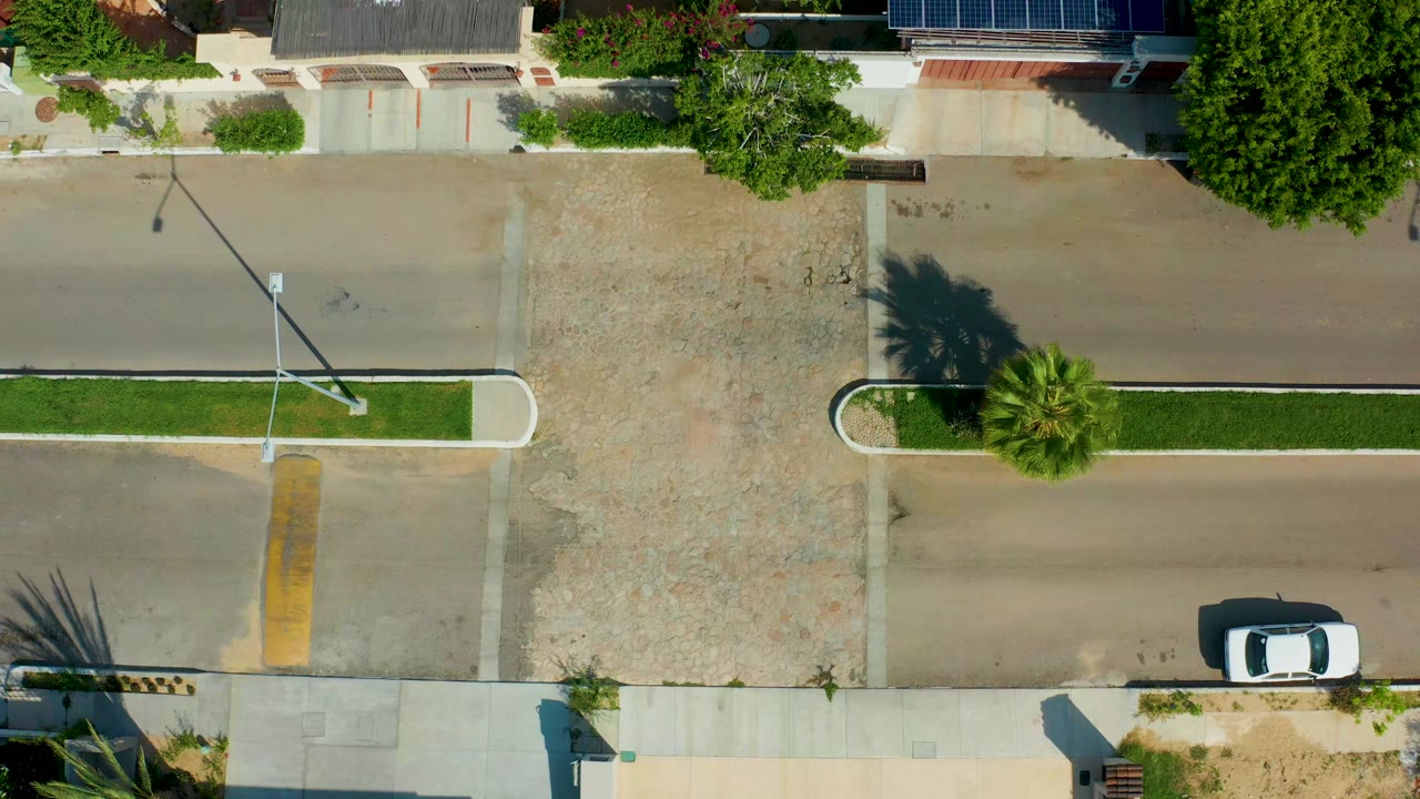 Aerial view of the same intersection as the streetlight leans over the road.
