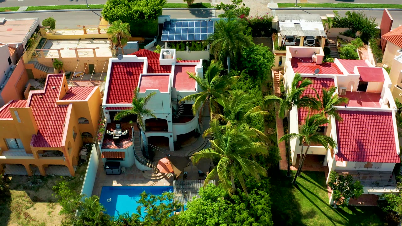 Closer overhead view of tropical homes and swimming pool
