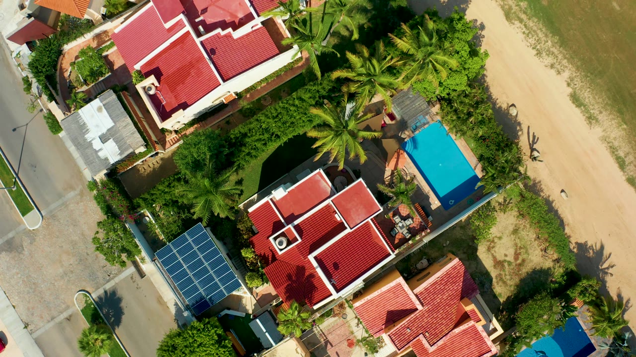 Beachside residential block with palms and blue pool