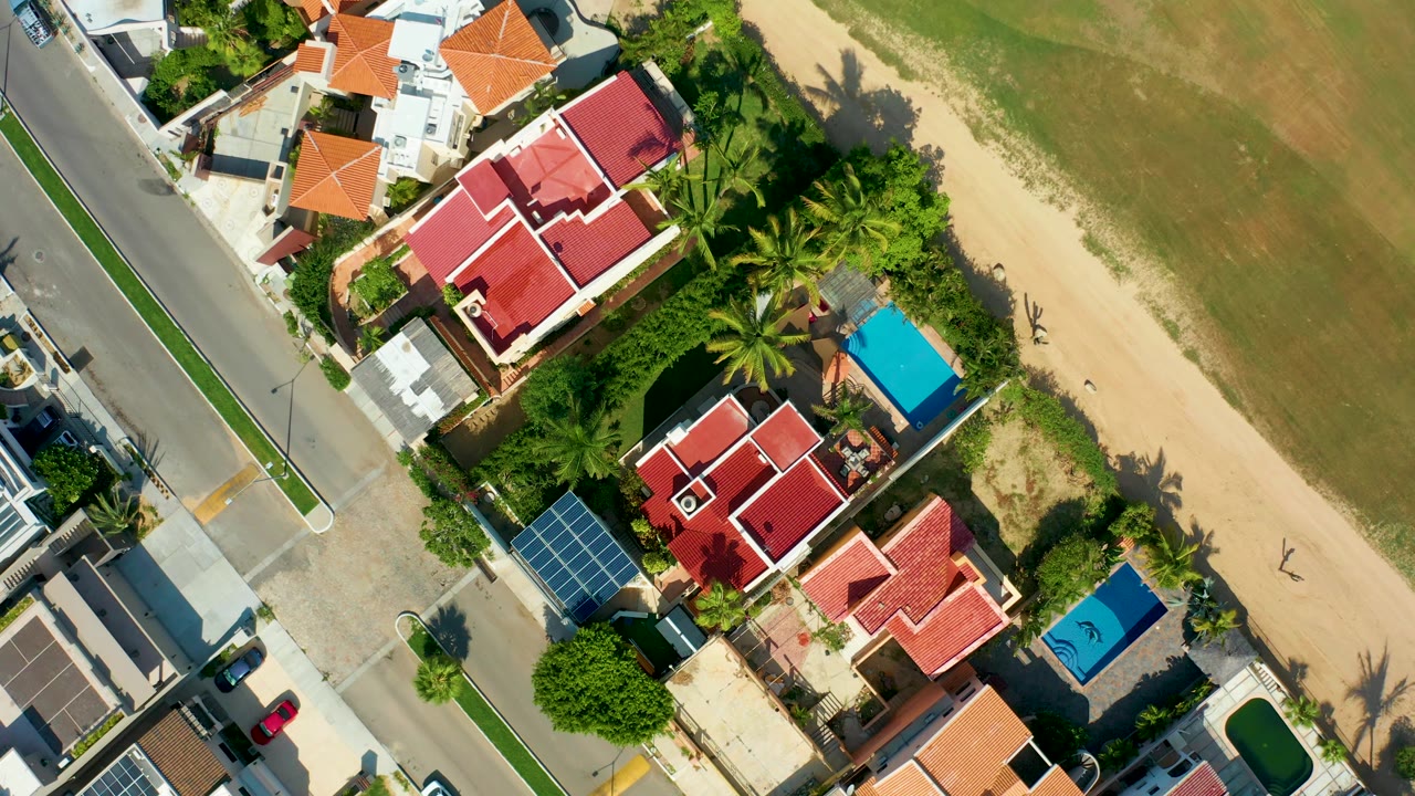 Beach-adjacent homes and road seen from directly overhead.