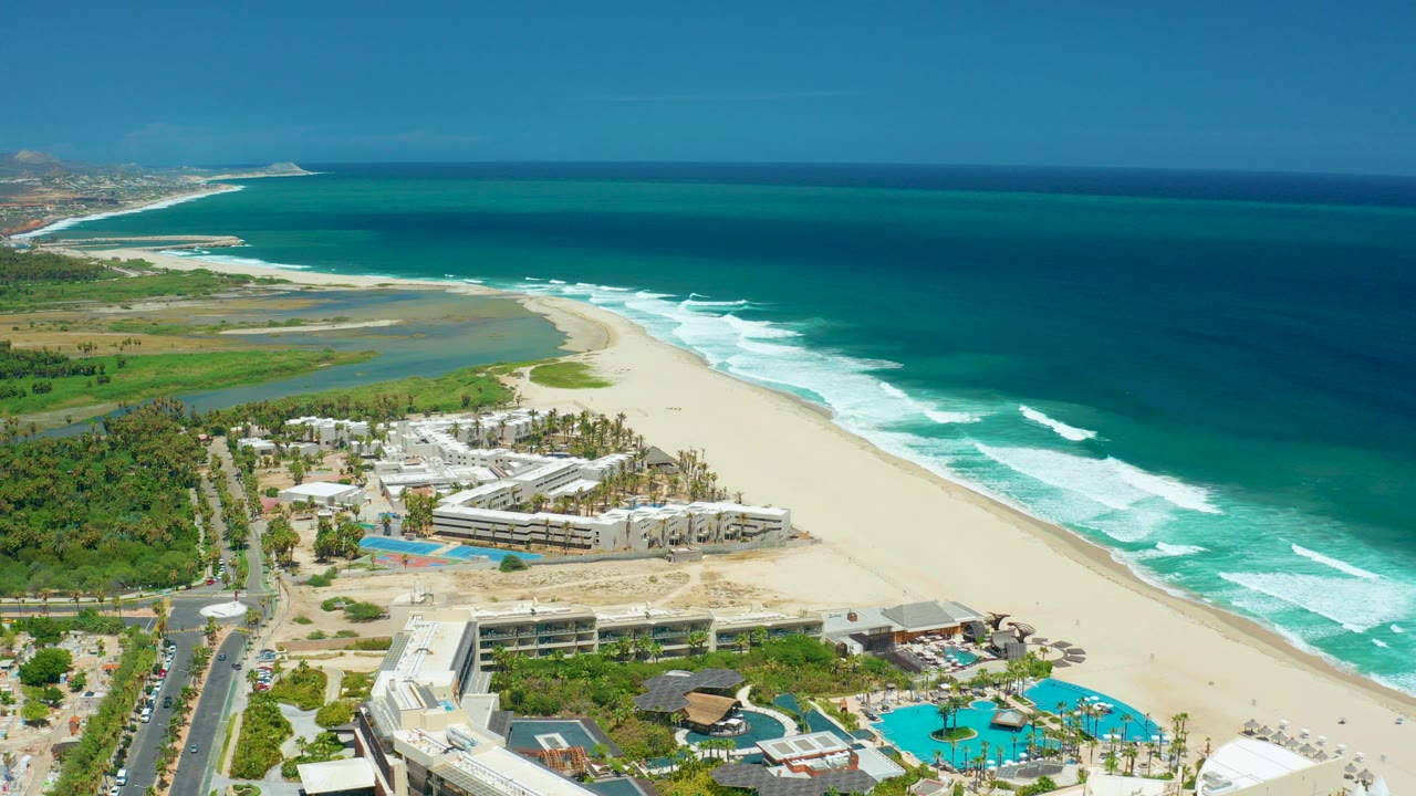 Aerial view of beach resort beside ocean surf