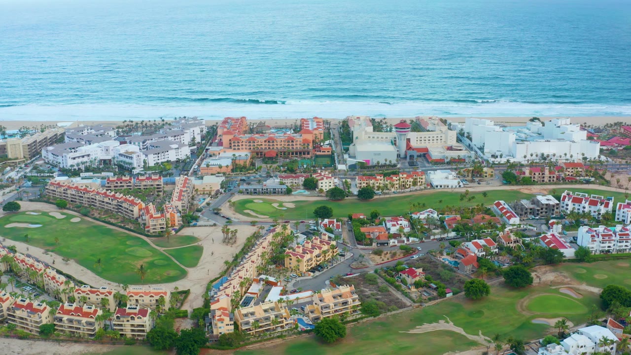 Aerial pan over residential buildings near beach and ocean