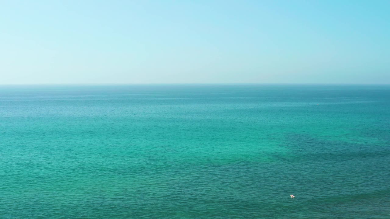 Third frame from El Tule Beach shows the buoy farther toward the lower right against calm turquoise water, with a clear horizon and no visible people.