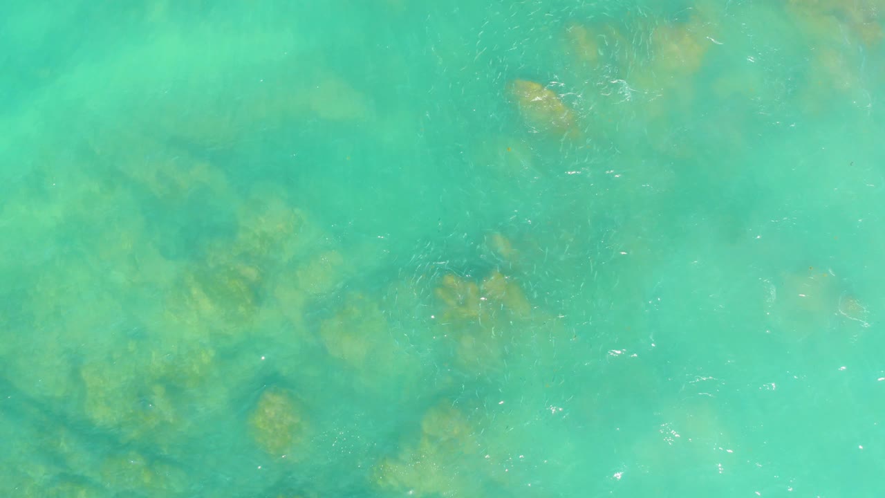Turquoise shallow water with darker underwater patches