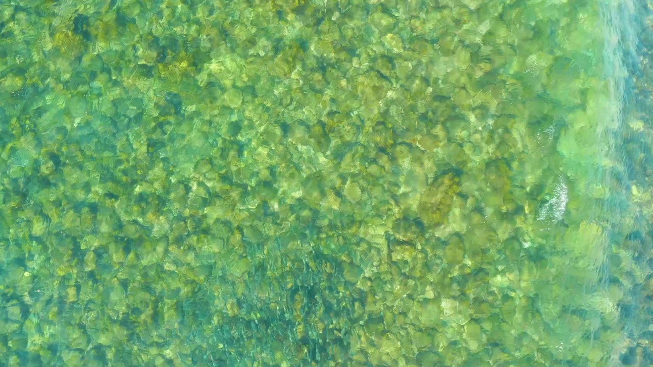 Clear green-blue water over a rocky seabed