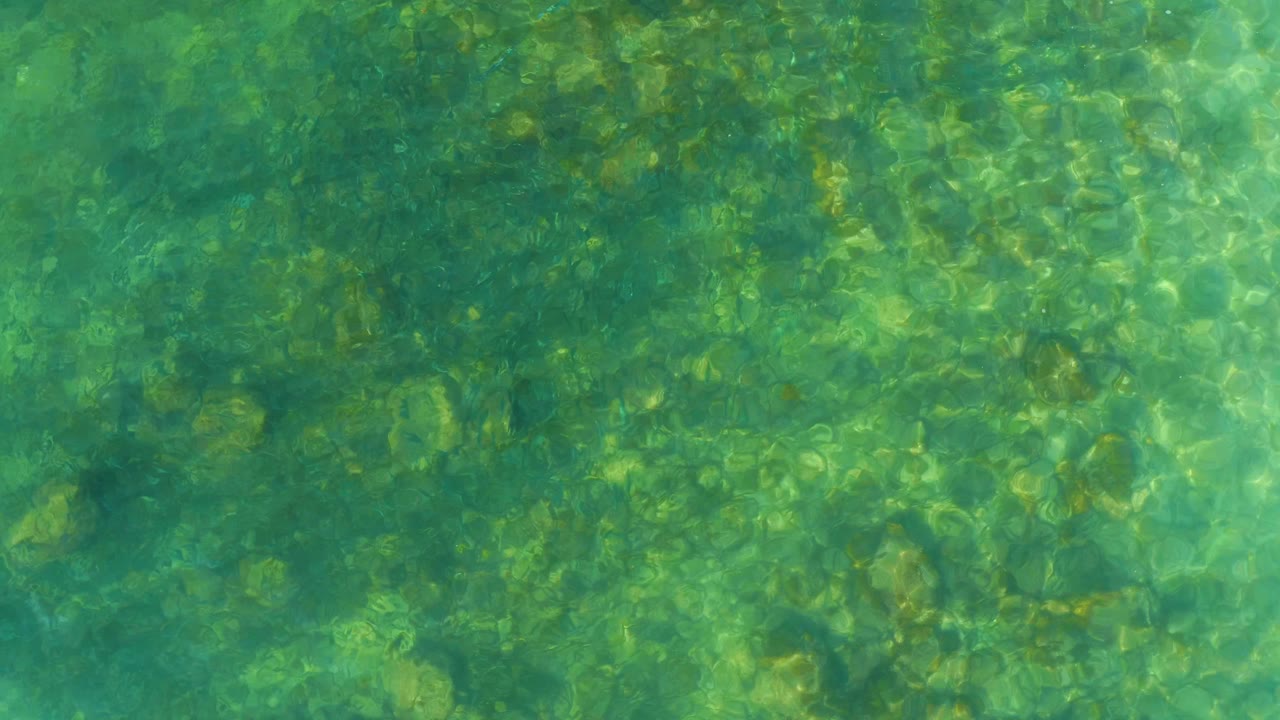 Clear green-blue shallow water over rocks