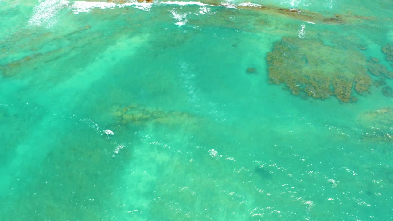 Turquoise ocean water over visible coral reef patches