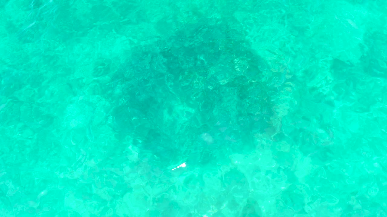 Rippled ocean surface over shallow rocks