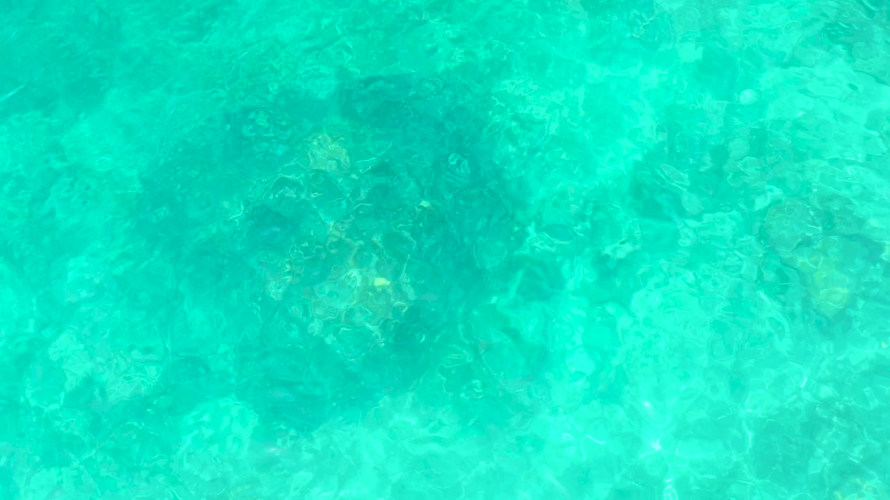 Blue green ocean water with sunlit ripples