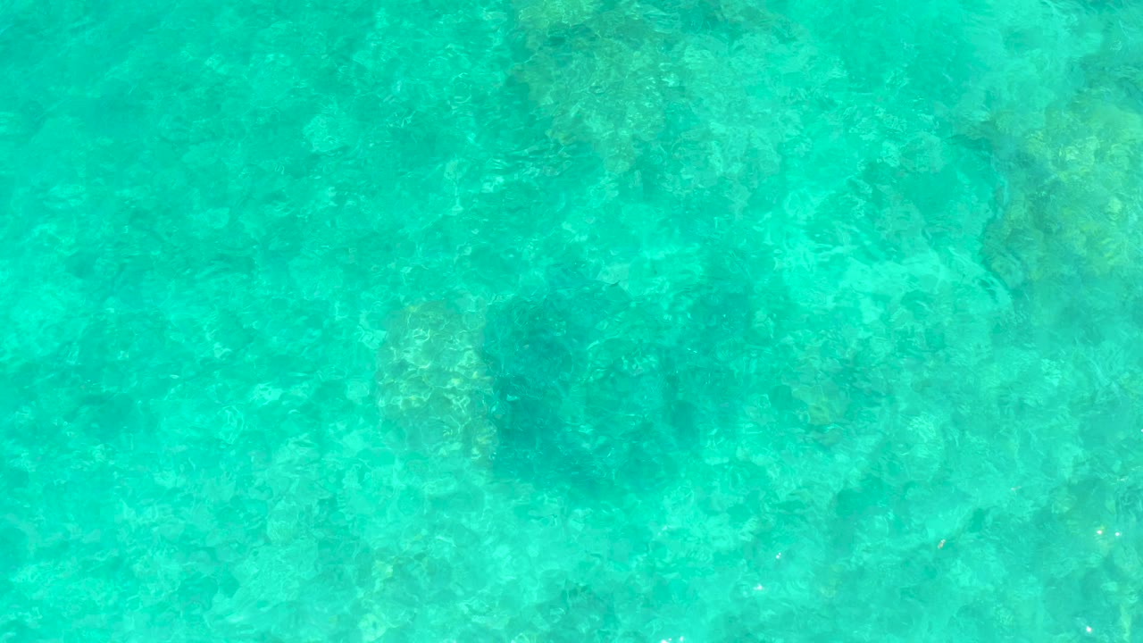 Clear turquoise water over rocky seabed