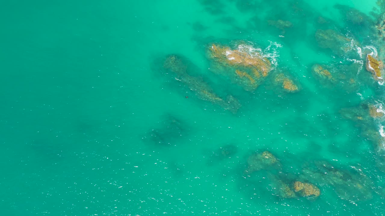 Clear turquoise water with rocks beneath the surface
