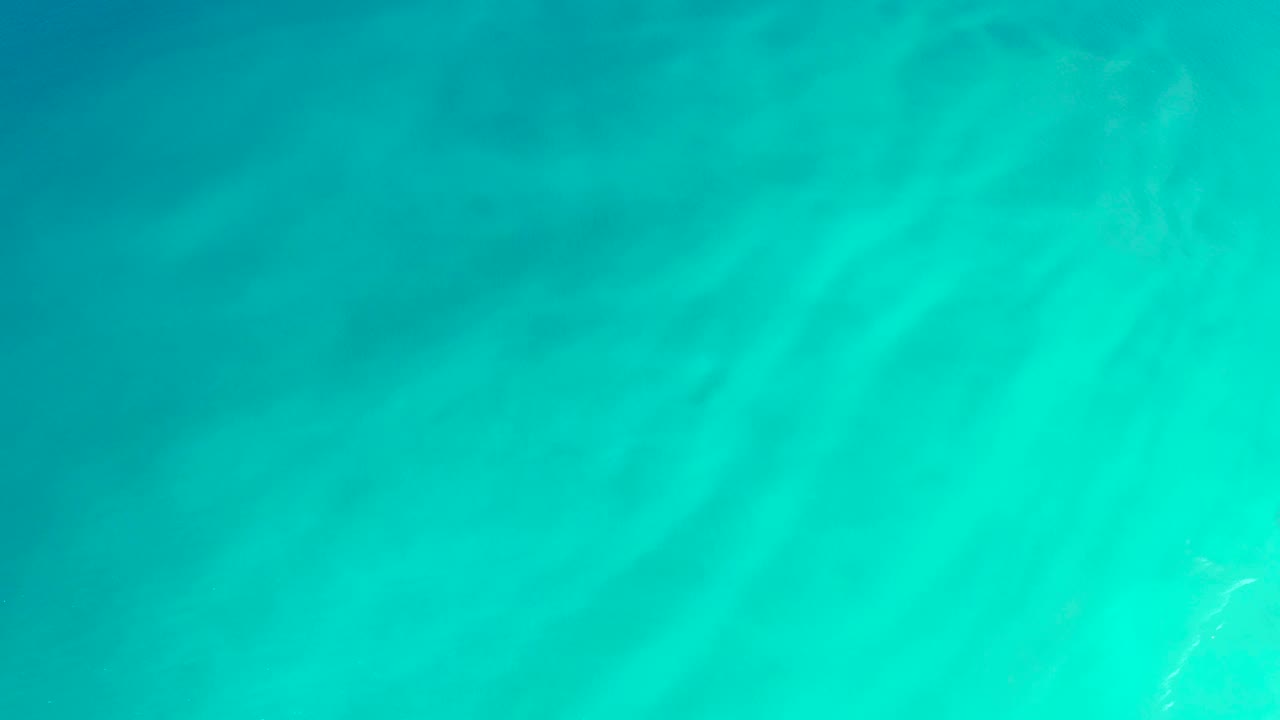 Shallow ocean surface with turquoise gradients
