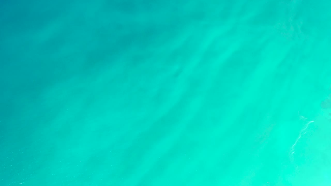 Overhead turquoise ocean water with soft ripples