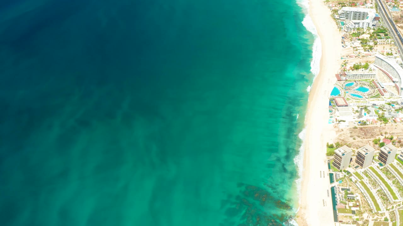 Overhead beach wave line beside resort grounds.