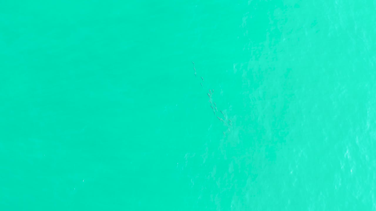 Turquoise sea surface at Los Frailes shows soft vertical foam streaks and pale underwater color variation, with no visible people.