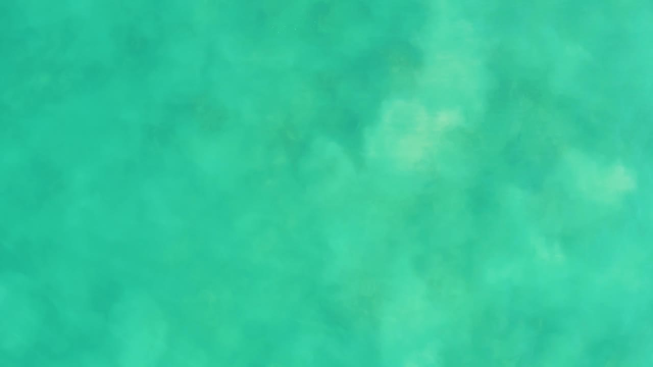Opening frame of turquoise shallow water at Los Frailes, Baja California Sur, with cloudy seabed detail visible below the surface and no visible people.