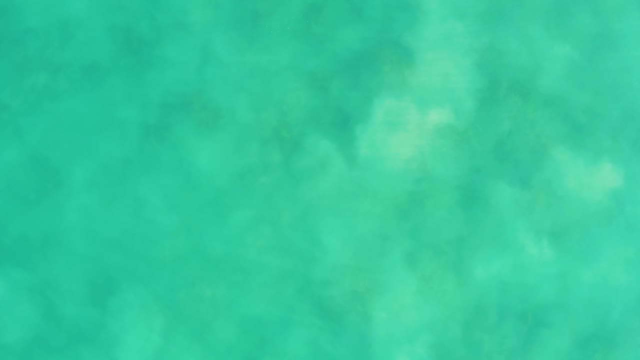 Turquoise-green water at Los Frailes shows soft underwater shapes and a slightly different pattern of light across the surface, with no visible people.