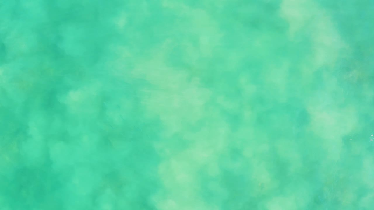 Overhead view of turquoise shallow water at Los Frailes with pale seabed texture and no visible people.