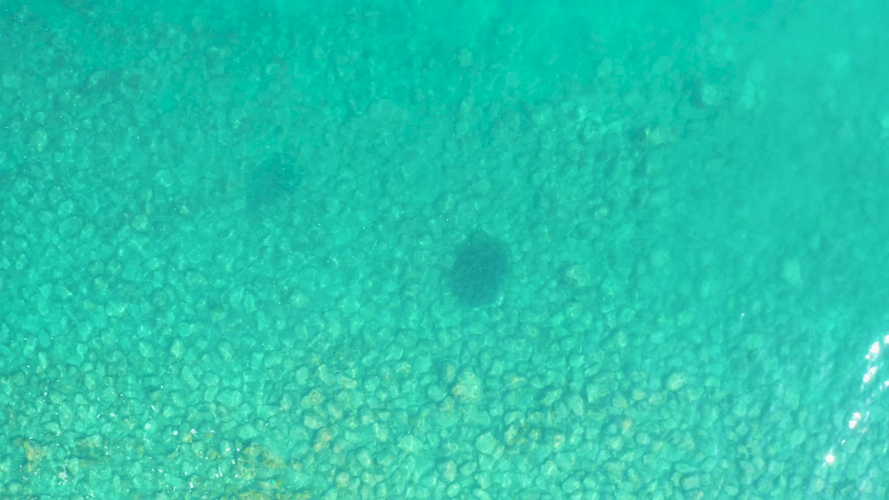 Turquoise shallow water over a rocky seabed