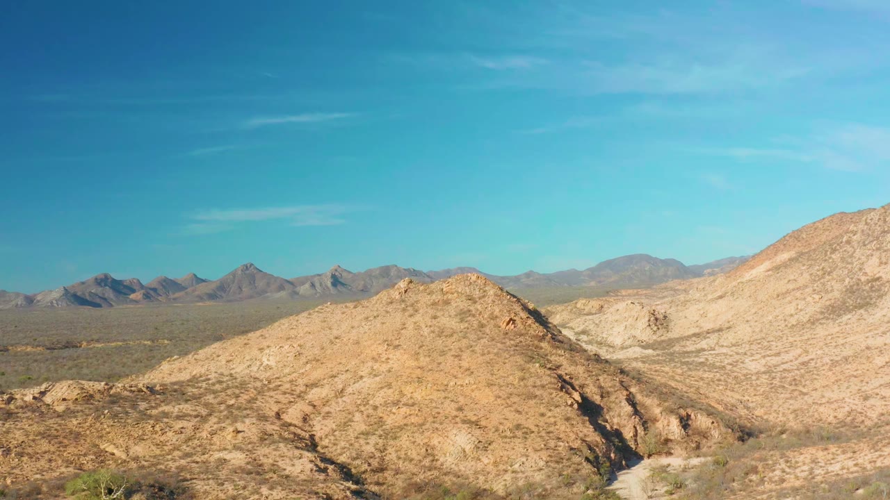 Rocky desert hills under a clear blue sky.