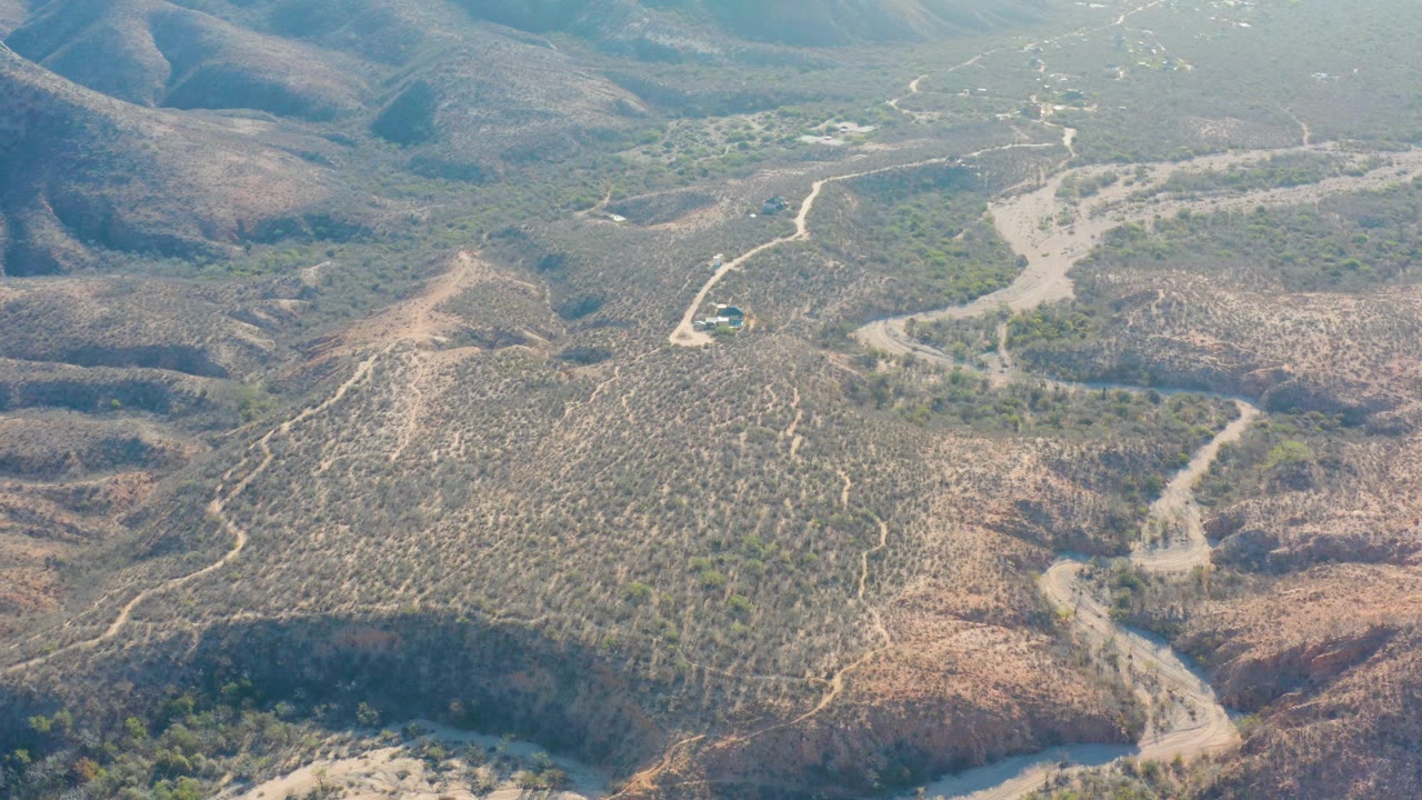 Aerial view of winding dirt roads through dry hills