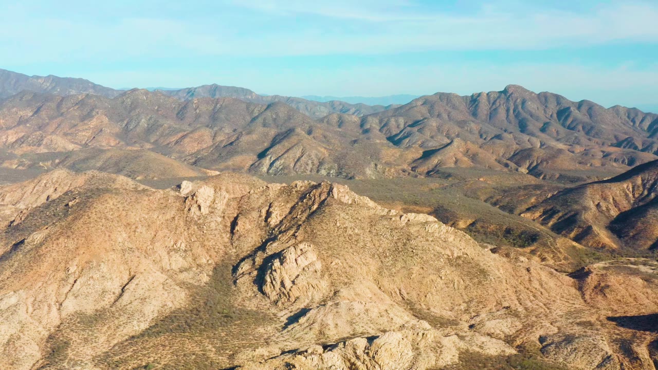 Second frame holds on the same Cabo Pulmo mountain range, with the foreground ridge brighter than the shadowed valleys behind it and no visible people.