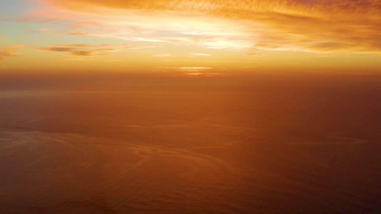 Golden sunset over a hazy ocean horizon