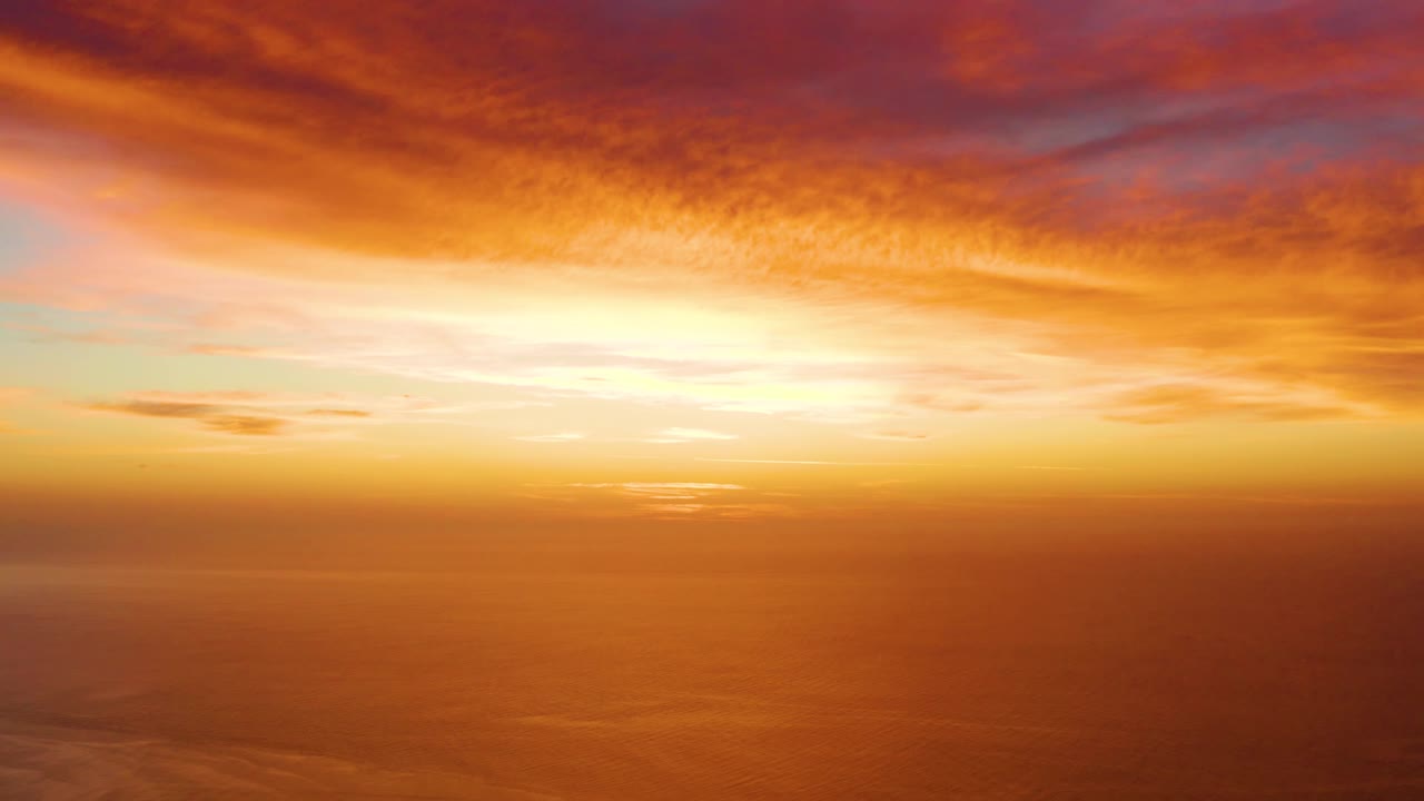 At 0:02 in Cabo Pulmo, a broad orange cloud ceiling sits over still ocean water and a clear horizon, with no visible people.