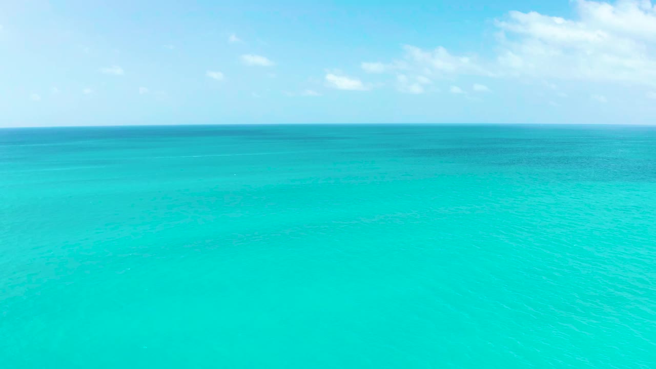 Second frame shows the turquoise sea off Marquis Los Cabos, faint surface texture, a straight horizon, and no visible people or vessels.