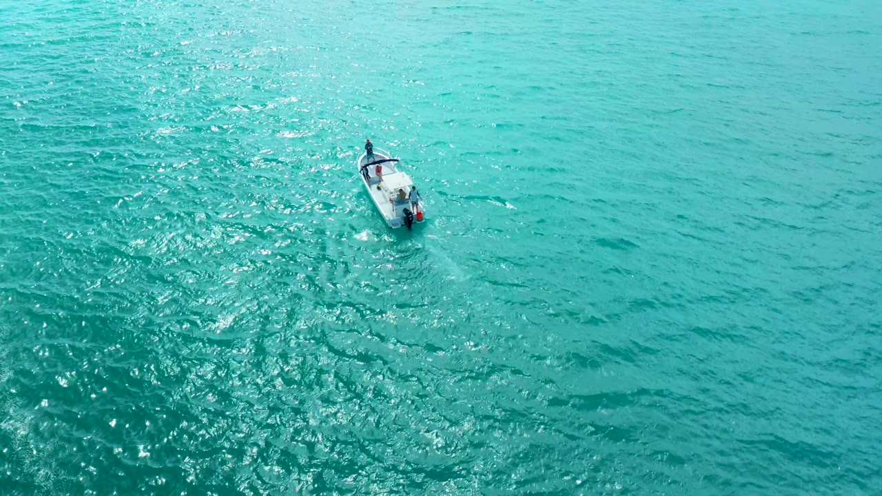 Small motorboat over turquoise ocean at Marquis Los Cabos, slightly farther across the frame with rippled water and no discernible people visible.