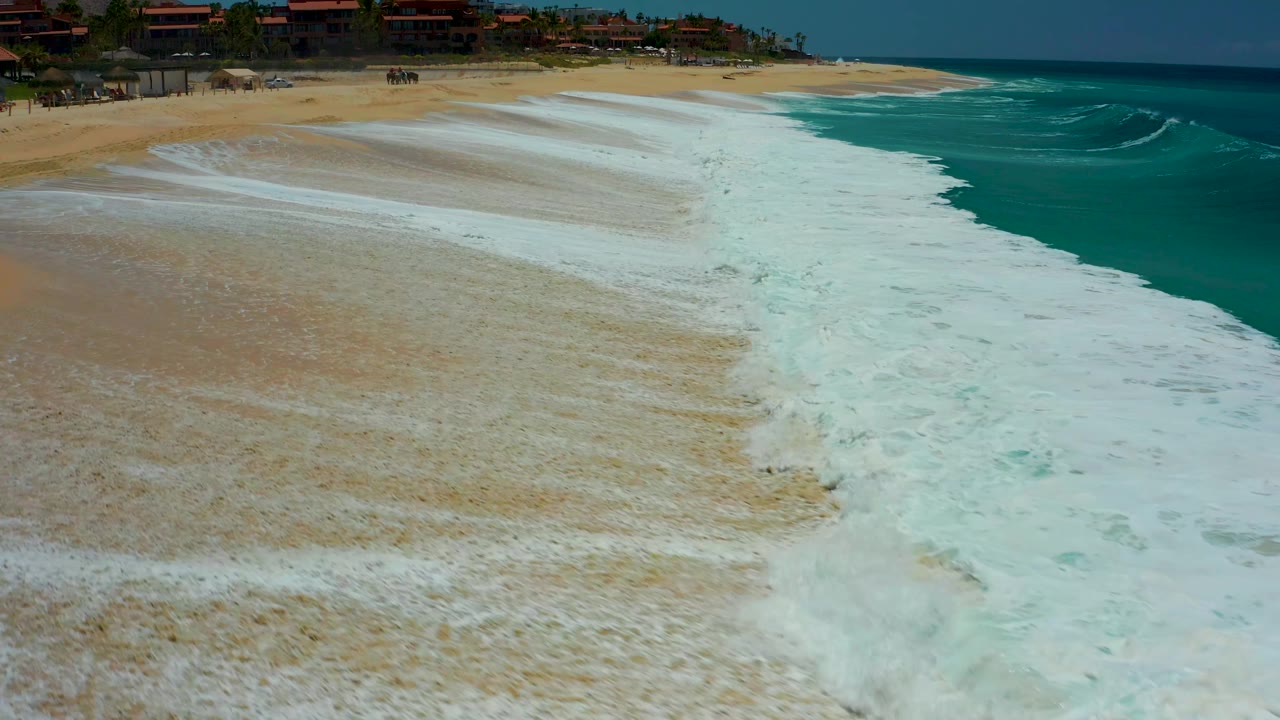 Wet beach with whitewater channel and ocean at right