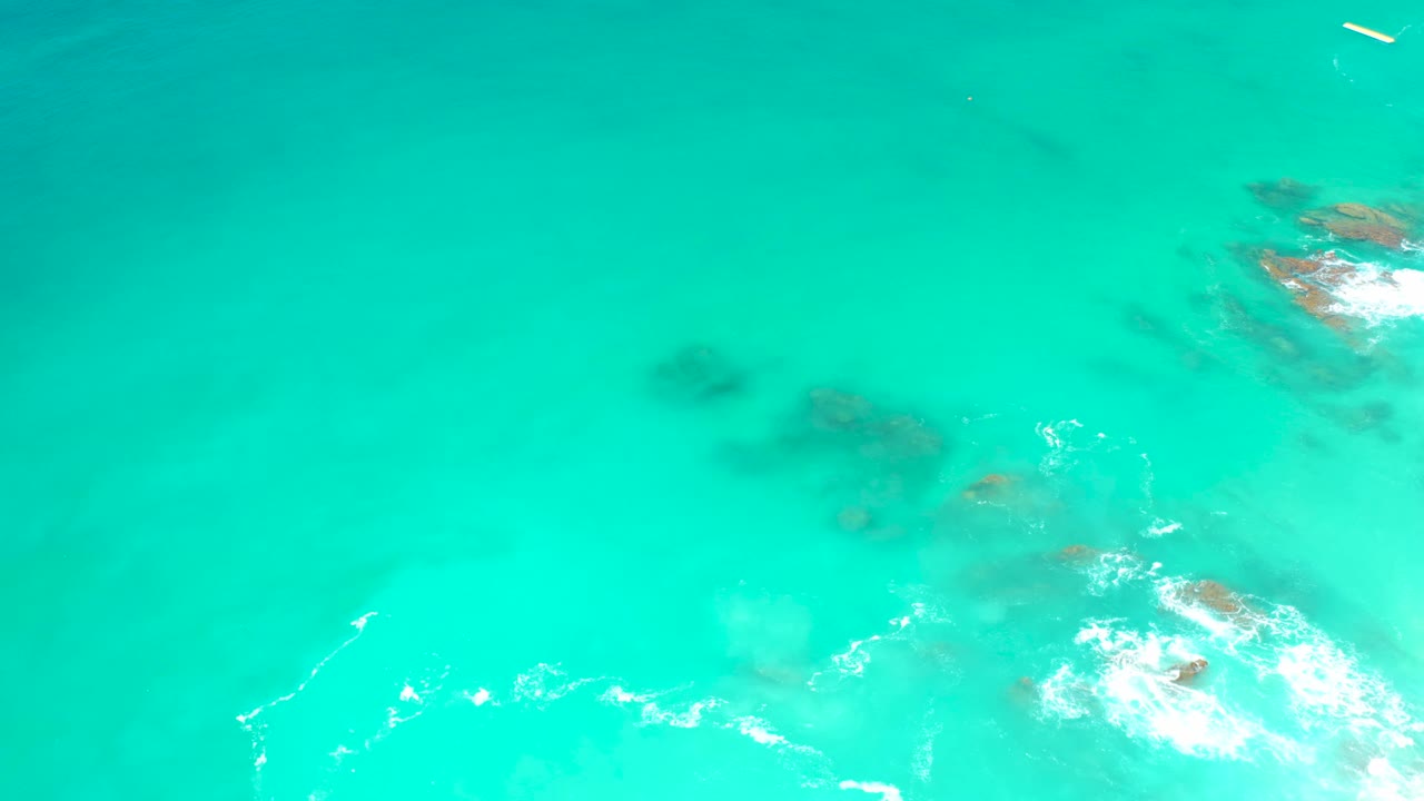 Clear turquoise ocean with rocks beneath the surface