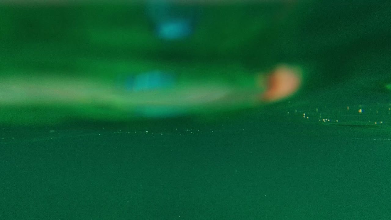 Green underwater view with bubbles near the surface