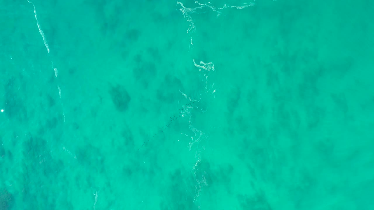 Turquoise ocean water with dark seabed patches