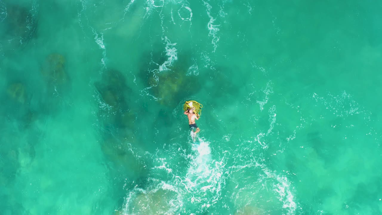 Yellow float moving through clear ocean water