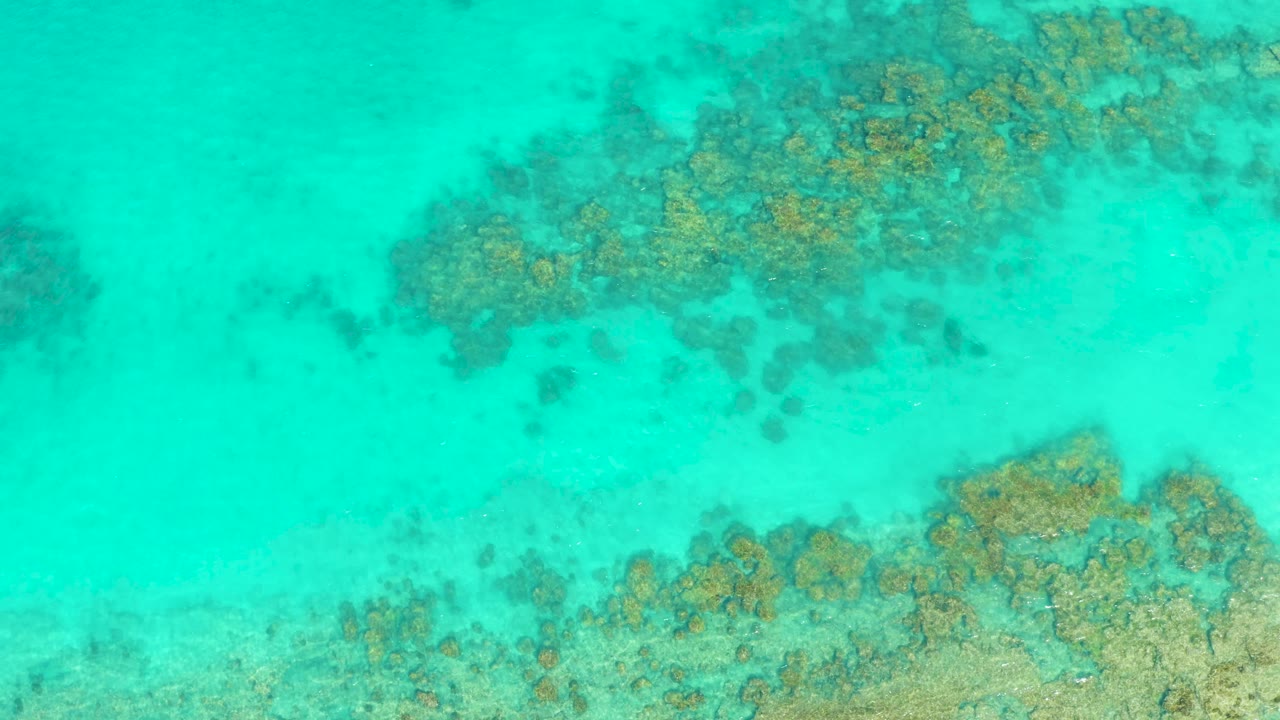 Turquoise shallow water over coral formations