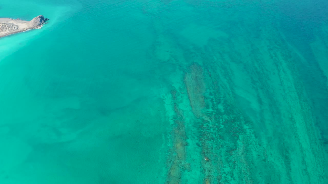 Small island at upper left over clear turquoise water