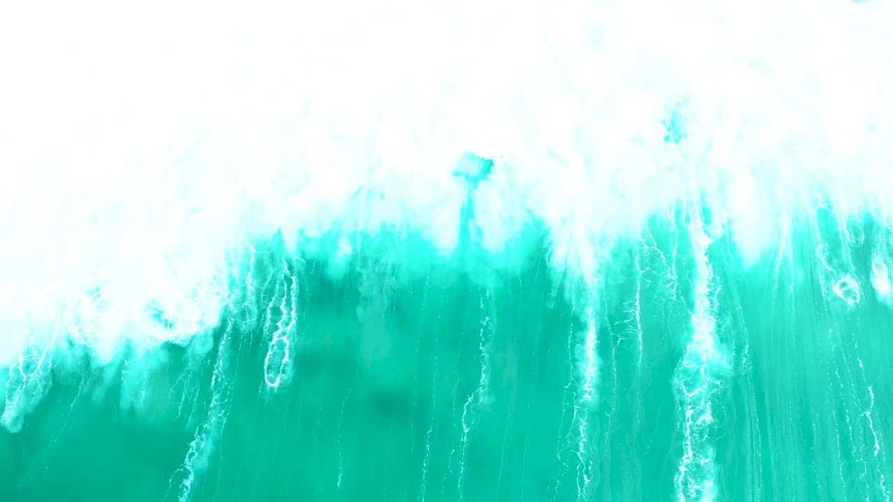 Overhead Marquis Los Cabos surf frame with bright whitewater at the top and long pale streaks running through turquoise water, with no visible people.