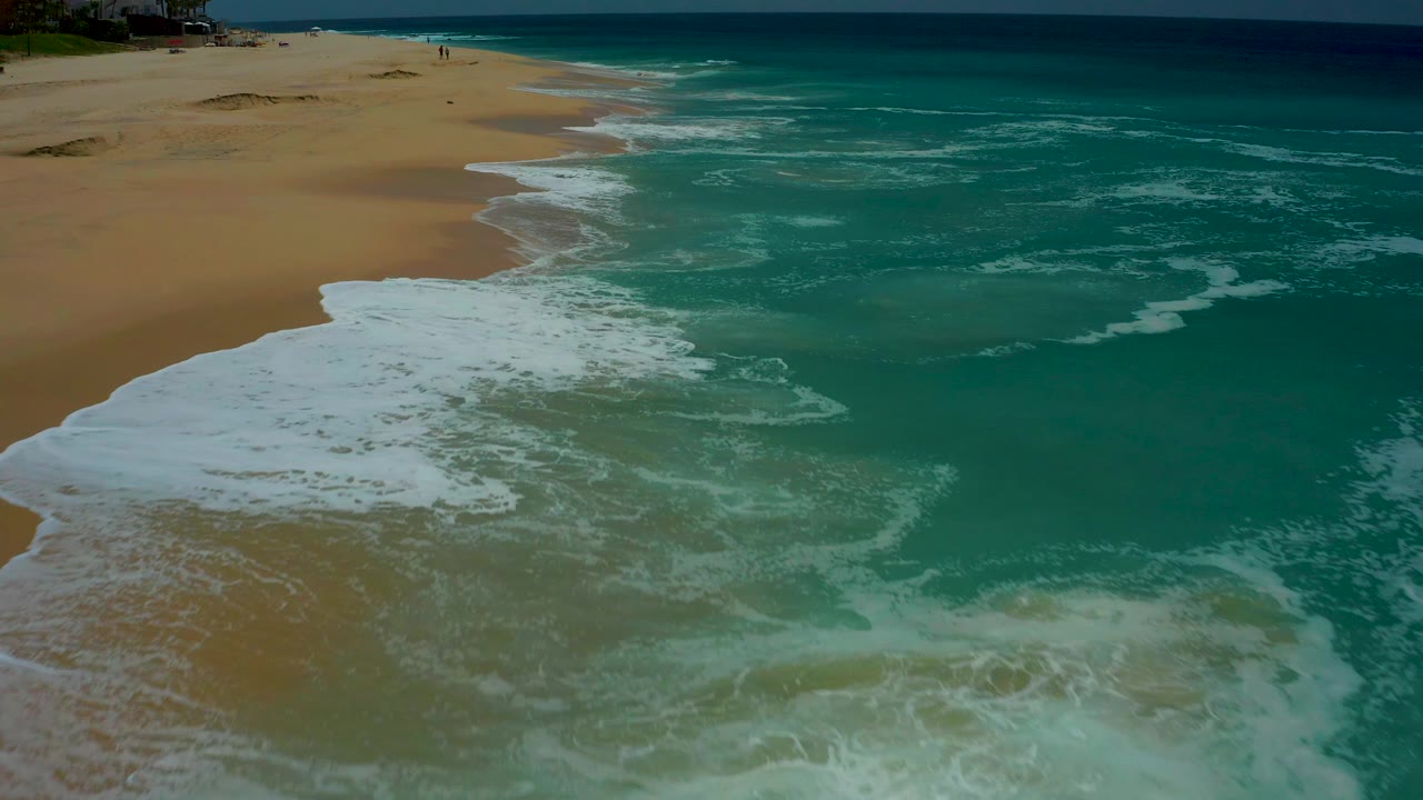 Turquoise waves washing onto a sandy beach