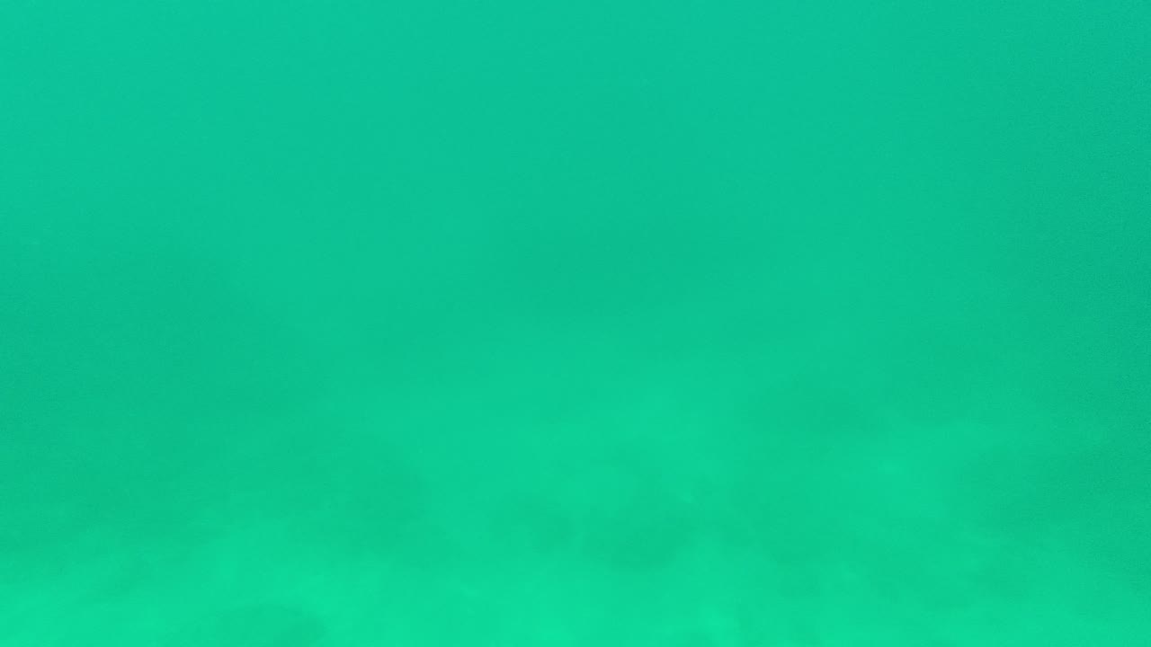 Clearer underwater view in Palmilla Los Cabos with turquoise water, sandy bottom texture, faint light bands, and no visible people.