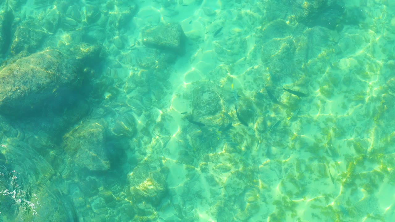 Turquoise water over a rocky seabed