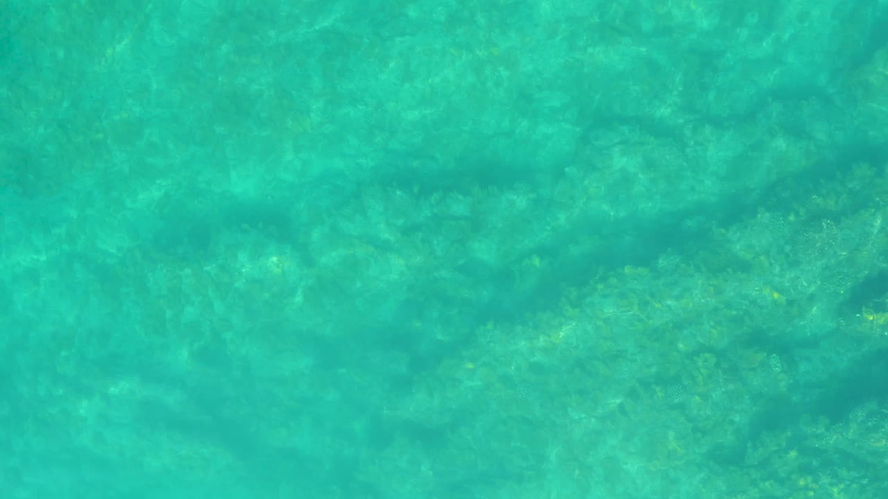 A slightly shifted pattern of turquoise water and submerged seabed fills the frame at Shipwrecks Los Cabos, Mexico, with no visible people.
