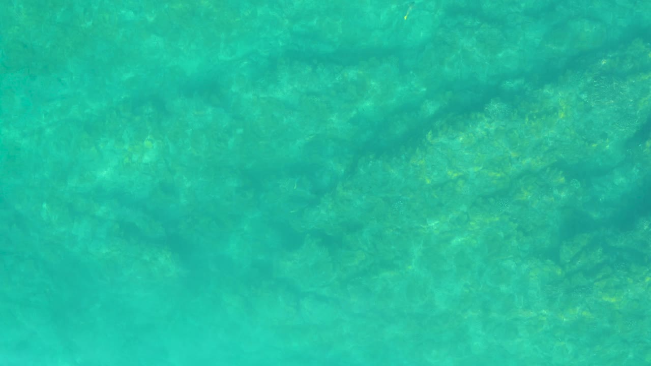 Clear turquoise water over a shallow rocky bottom