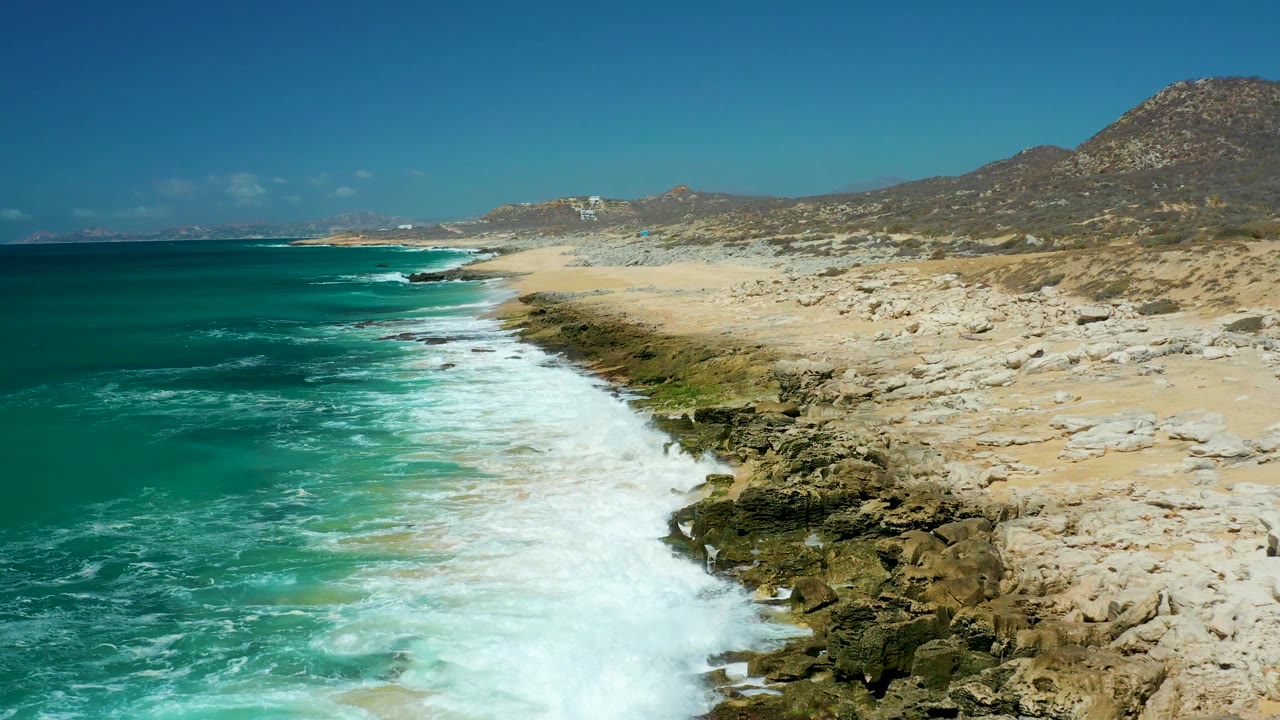 Foam band running diagonally along a rocky beach.