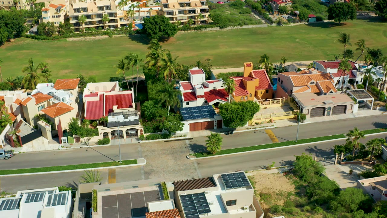 Houses and a road with a small white car visible.