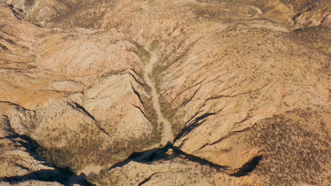 Overhead view of arid canyon ridges and wash
