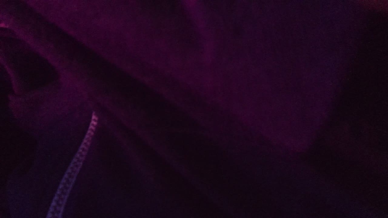 A tight San Jose Del Cabo 2022 frame shows dark purple jacket fabric with a pale zipper edge along the lower left and no visible face.