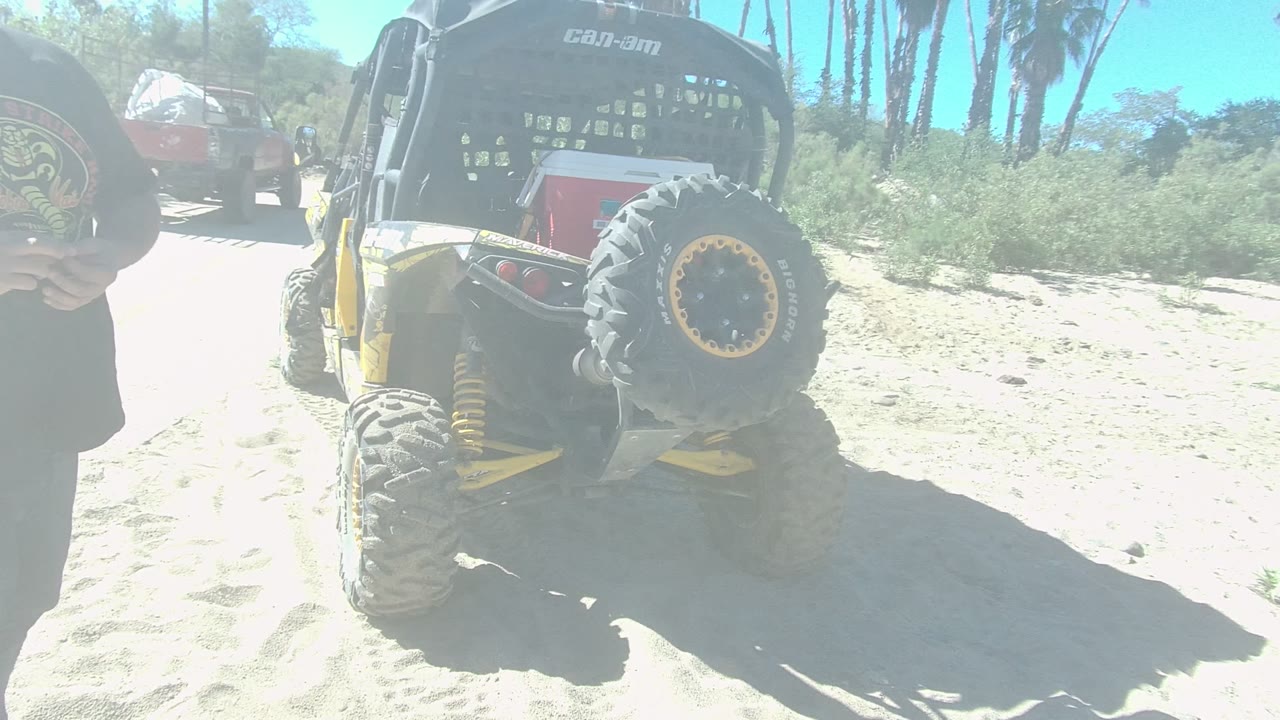 Red disc partly enters the foreground near an off-road vehicle.